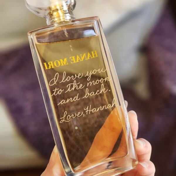 calligraphy message hand engraved on the back of perfume bottle