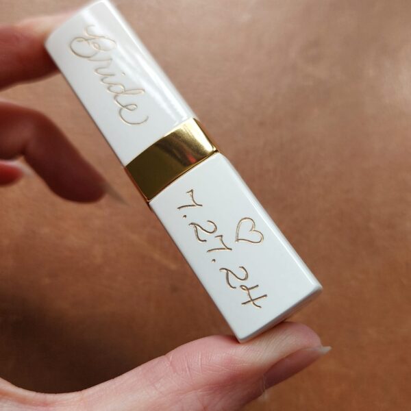 white chanel lipstick with 'Bride' and wedding date engraved in gold calligraphy