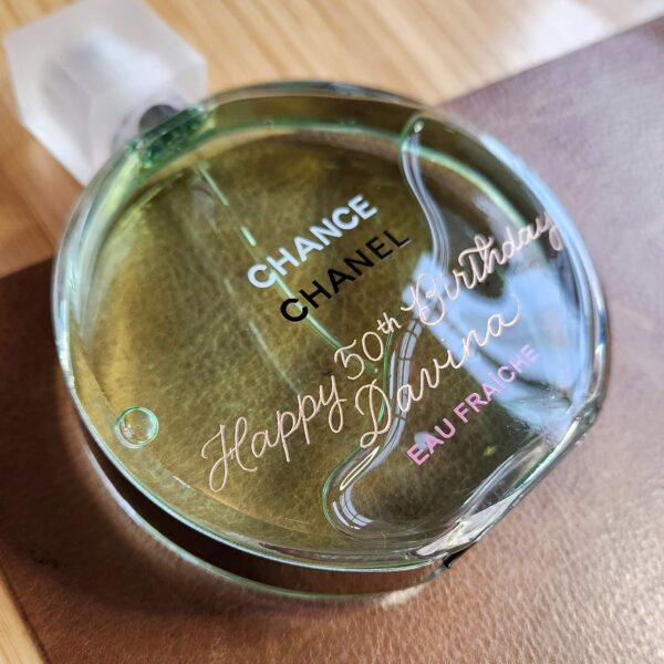 chanel chance bottle engraved with "Happy 50th Birthday" on the front in calligraphy