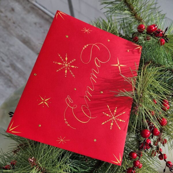 Decorated red envelope with gold calligraphy name and snowflakes for Santa Letter