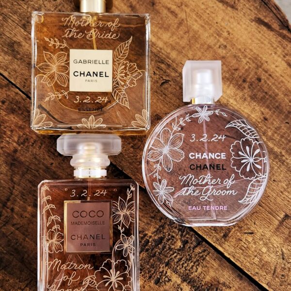 chanel chance, chanel gabrielle, and chanel mademoiselle perfume bottles hand engraved with tropical flowers and calligraphy for wedding gifts