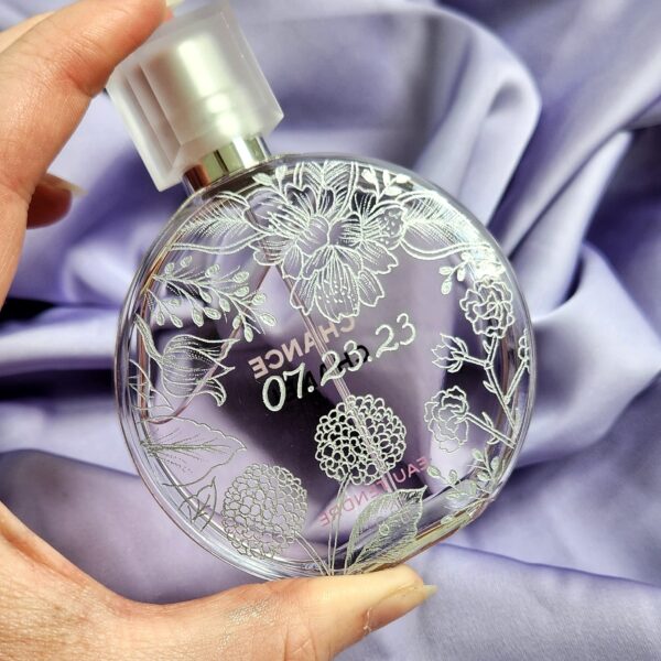 engraved chanel chance bottle with wedding date and wedding invitation flowers