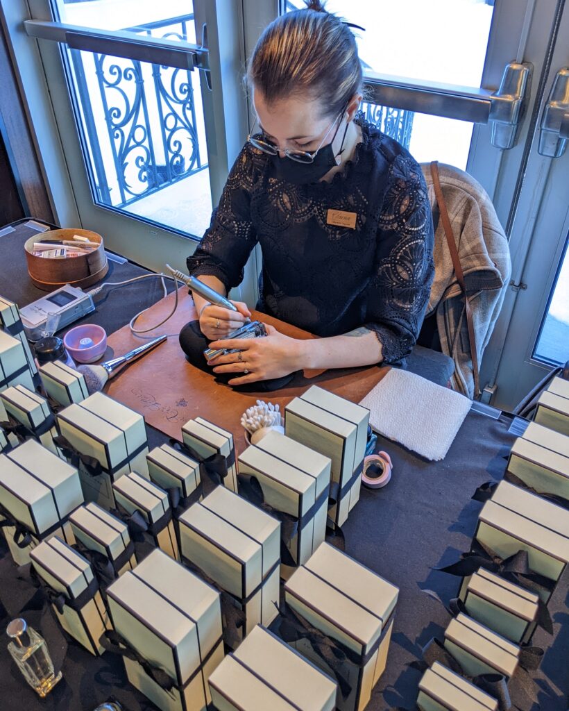 On-site engraving for an employee appreciation event with perfume bottle personalization for guests.